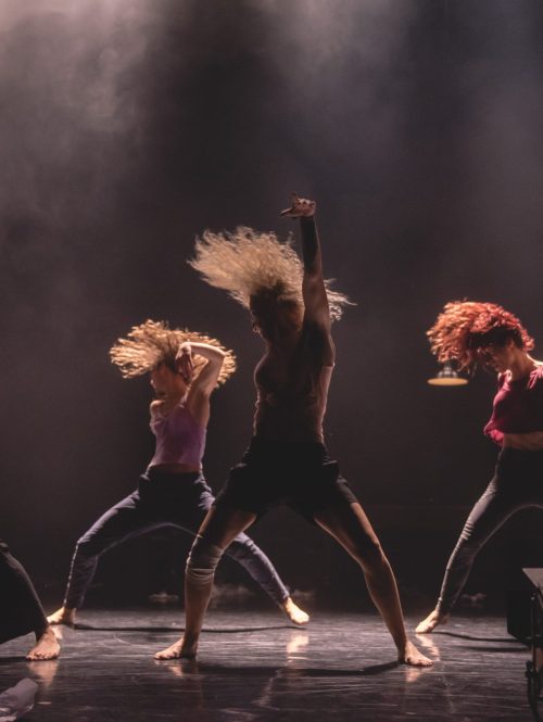 Four dancers performing on a stage