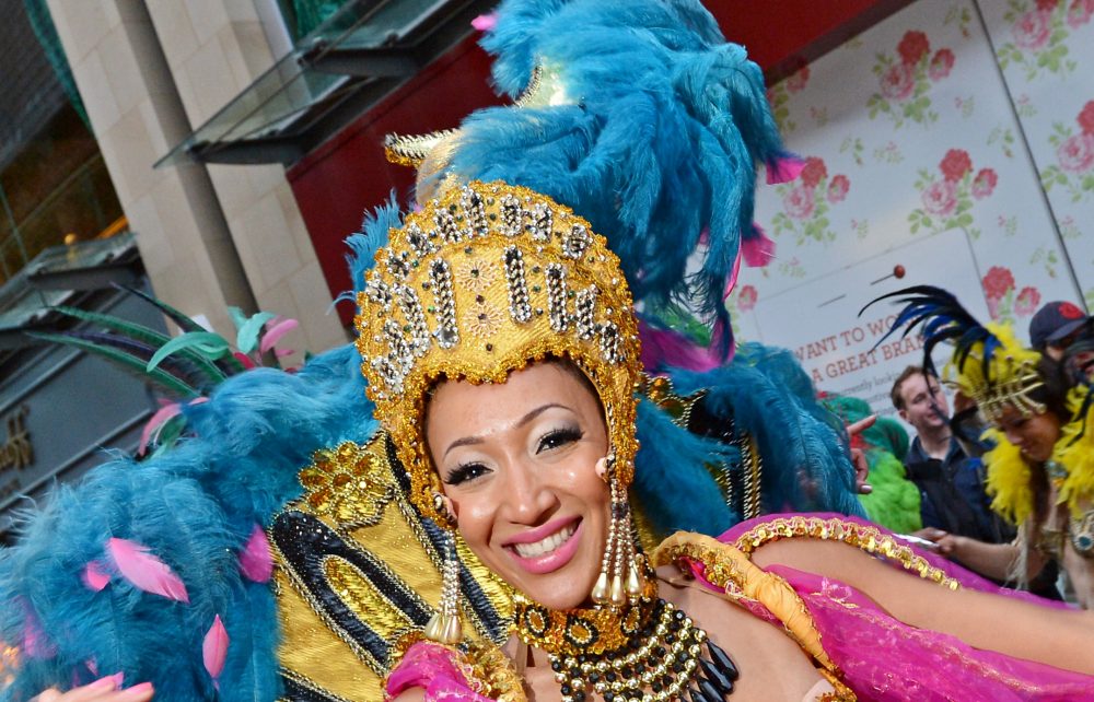 A close-up photo of a woman in a colourful carnival costume.