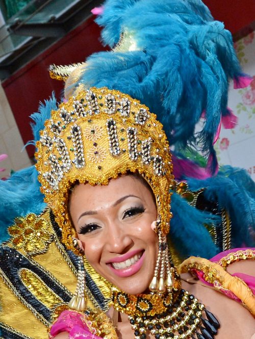 A close-up photo of a woman in a colourful carnival costume.