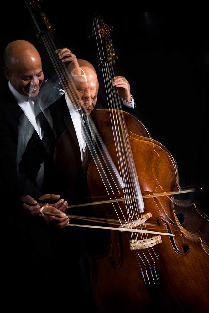 An image of Leon Bosch playing the double bass in motion.