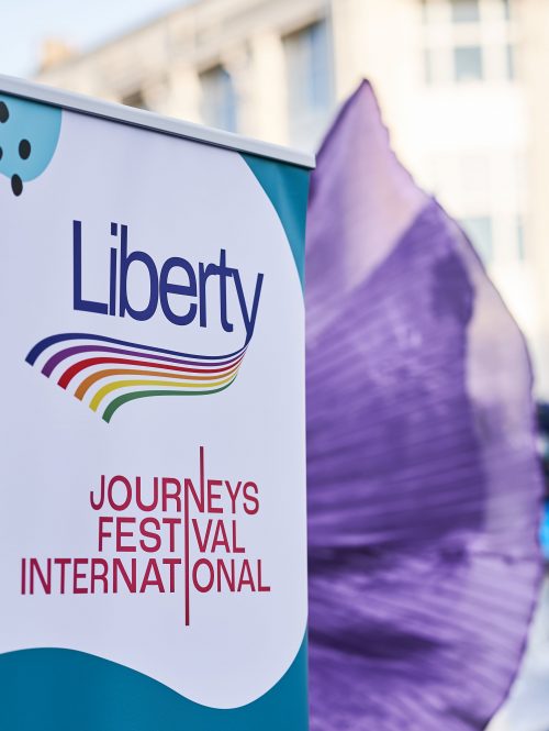 This image shows a pull up banner which reads, Liberty, and also Journeys Festival International.