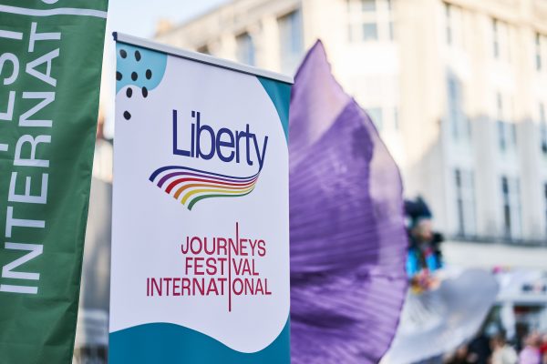 This image shows a pull up banner which reads, Liberty, and also Journeys Festival International.