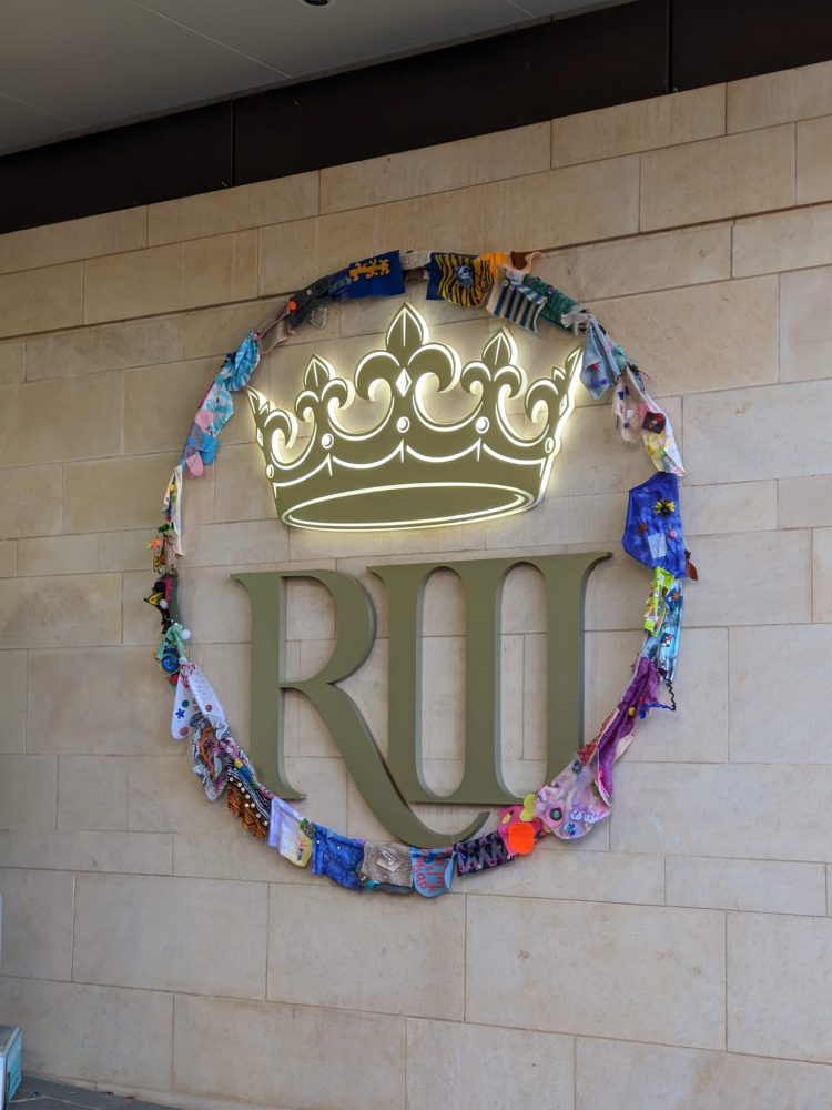 Giant sequins displayed in a hoop around the logo of King Richard III Visitor Centre.